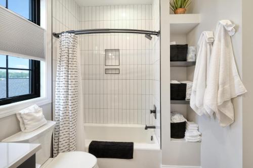 a white bathroom with a shower and a toilet at La Dolce Vita in Ottawa