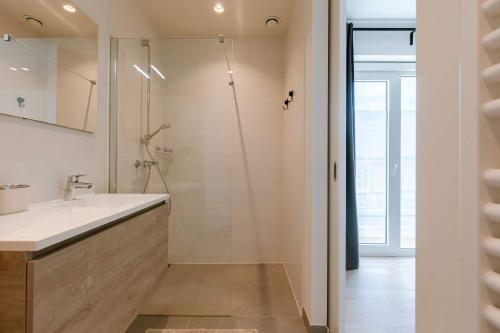 a bathroom with a sink and a shower at Huswell - Spacious apartment in Ghent with big terrace in Ghent