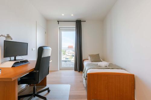 a room with a desk with a computer and a bed at Huswell - Spacious apartment in Ghent with big terrace in Ghent