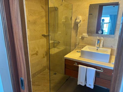 a bathroom with a sink and a glass shower at Lifestyle Cabarate in Cabarete