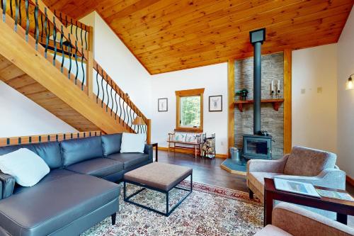 a living room with a couch and a fireplace at Ferncrest Mountain House in Conway