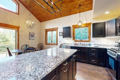a large kitchen with a large counter top in a house at Ferncrest Mountain House in Conway