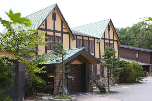 an exterior view of a building with a garage at Dormy Club Karuizawa in Karuizawa