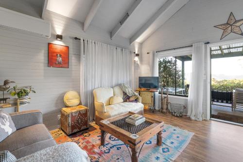 a living room with a couch and a table at Martha's Villa - panoramic, peaceful location in Kangaroo Valley