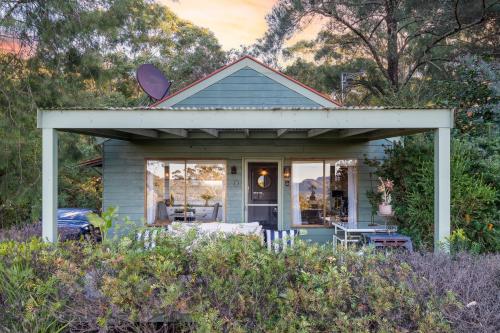 a small blue house with a porch at Martha's Villa - panoramic, peaceful location in Kangaroo Valley