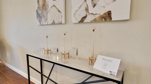 a glass table with candles on it in a room at Elegant 5BR 2,5BA Holiday Home with Pool, Jacuzzi, BBQ, and Cinema Room in Farmers Branch