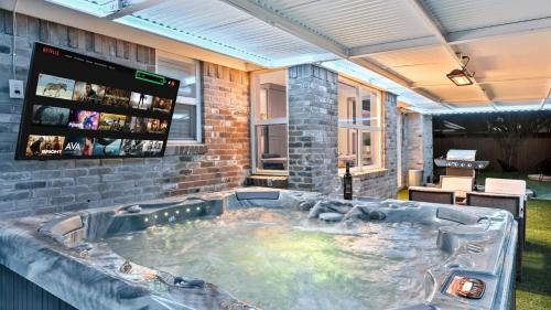 a large hot tub in the middle of a room at Elegant 5BR 2,5BA Holiday Home with Pool, Jacuzzi, BBQ, and Cinema Room in Farmers Branch