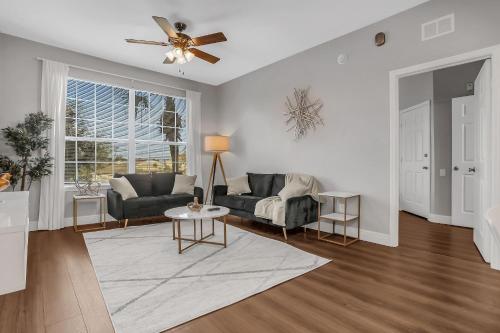 a living room with a couch and a ceiling fan at 3Bd/2Ba Elegant Condo with Resort Access in Orlando