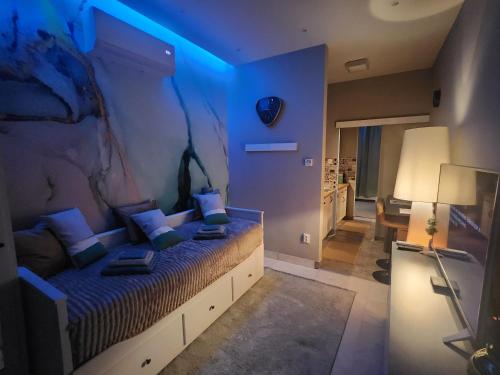 a bedroom with a bed with a blue light at Emma's Cottage in Debrecen