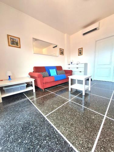 a living room with a red couch and a table at Casa Angelo in Recco