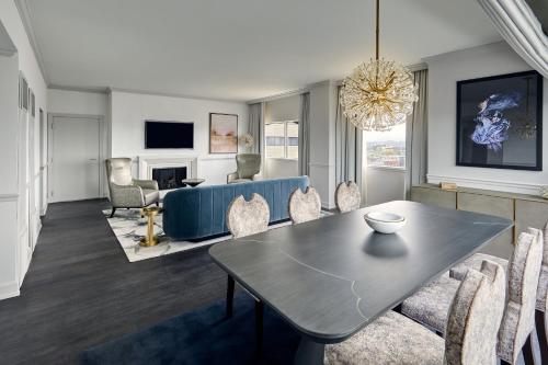a living room with a table and chairs at Loews Nashville Hotel at Vanderbilt Plaza in Nashville