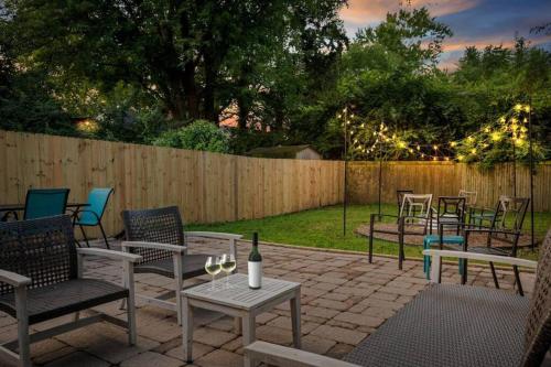 a patio with chairs and a table with a bottle of wine at Close to Butler Uni, Cozy Home,Firepit,Free Parking in Indianapolis