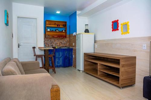 a living room with a couch and a refrigerator at Pousada Flat Castor in Natal
