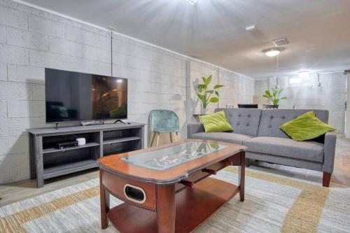 a living room with a couch and a tv at Close to Butler Uni, Cozy Home,Firepit,Free Parking in Indianapolis