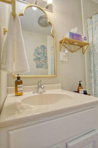 a white bathroom with a sink and a mirror at Close to Butler Uni, Cozy Home,Firepit,Free Parking in Indianapolis