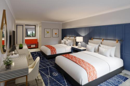 a hotel room with two beds and a television at Tiller House, Laguna Hills, a Tribute Portfolio Hotel in Laguna Hills