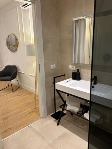 a bathroom with a white sink and a mirror at Casa Lounge Costituzione in Cagliari