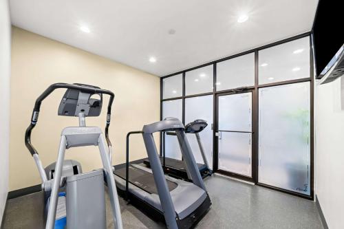 a gym with two tread machines in a room with windows at Best Western Plus Mariposa Inn & Conference Centre in Orillia