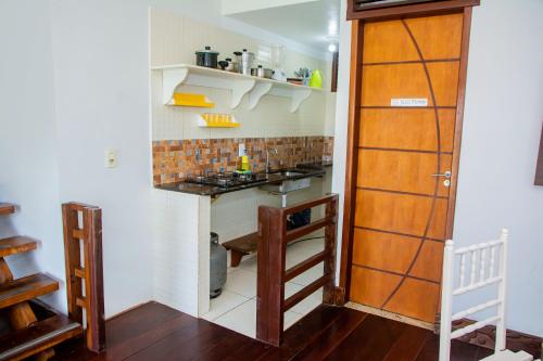 a small kitchen with a sink and a counter at Pousada Flat Castor in Natal