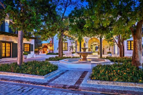 a fountain in the middle of a courtyard with trees at Sanctuary Cap Cana, a Luxury Collection Resort, Dominican Republic, Adult All-Inclusive in Punta Cana
