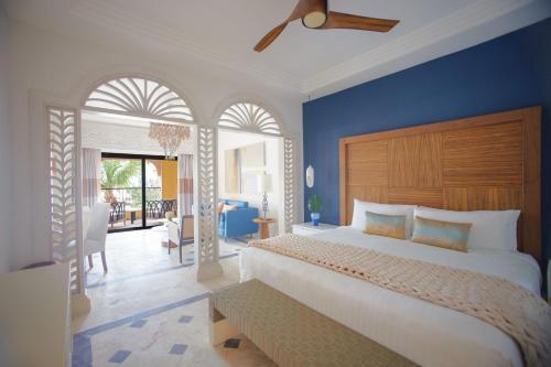 a bedroom with a large bed with a blue wall at Sanctuary Cap Cana, a Luxury Collection Resort, Dominican Republic, Adult All-Inclusive in Punta Cana