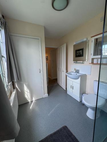a bathroom with a toilet and a sink at Spacious home in Bath, nature and city! in Bath