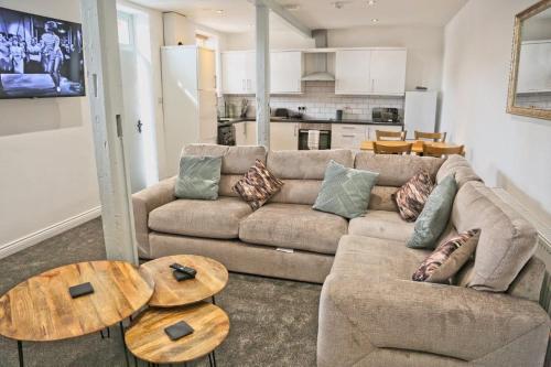 a living room with a couch and a table at White Swan Cottage in Hunmanby