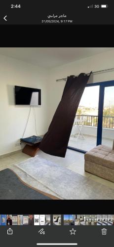 a picture of a living room with a slide at Marassi in Alexandria