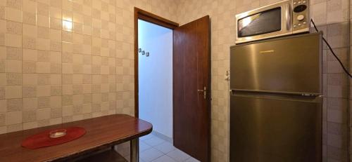 a kitchen with a refrigerator and a microwave on top of it at Central Residence in Ploieşti