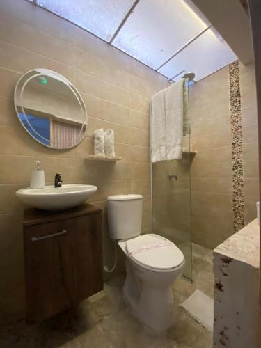 a bathroom with a toilet and a sink and a mirror at Balcones de Venecia in Cartagena de Indias
