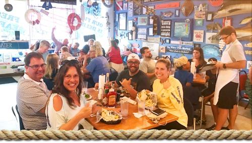 a group of people sitting at a table in a restaurant at Newly remodeled 8-steps to sand path of Beach! in Siesta Key