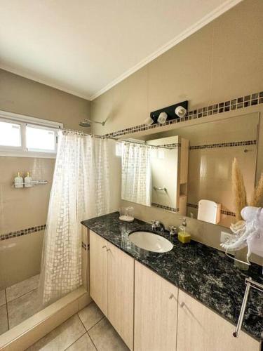 a bathroom with a sink and a mirror at Casa Laguna de Gomez, con increíble vista a la laguna- in Junín