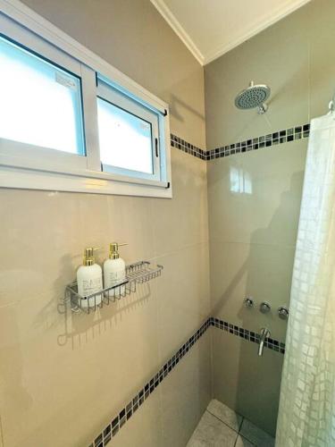 a bathroom with a shower and a window at Casa Laguna de Gomez, con increíble vista a la laguna- in Junín