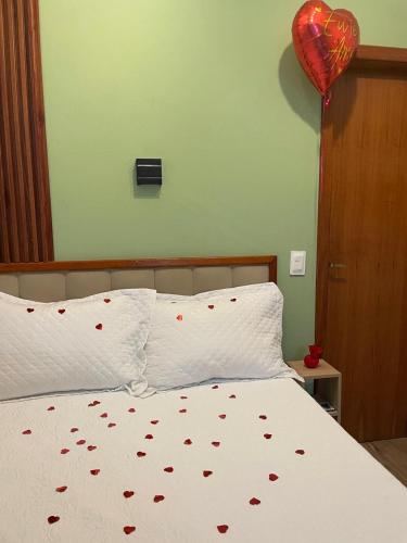 a bedroom with a bed with a red heart balloon at Espaço da Zilda in São José