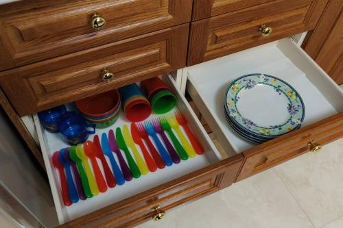 a drawer with colorful cups and plates in it at オーシャンビューテラス伊豆 in Futo