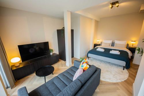a living room with a bed and a couch at Kerkstraat in Hilversum