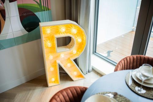 a wooden letter a sitting on the floor next to a table at Kerkstraat in Hilversum