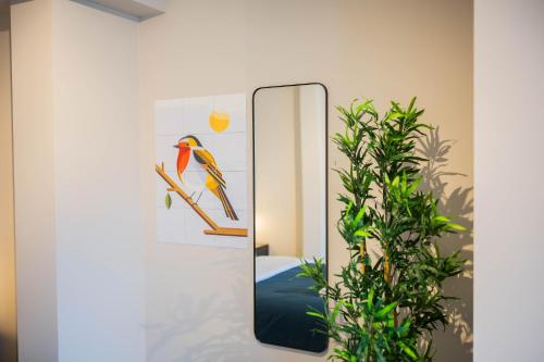 a mirror with a picture of a bird on a branch at Kerkstraat in Hilversum
