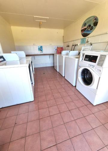 a laundry room with several washers and dryers at Country Style Holiday Park in Stanthorpe