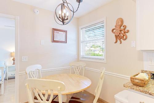 a dining room with a table and chairs at Newly remodeled 8-steps to sand path of Beach! Unit A in Siesta Key