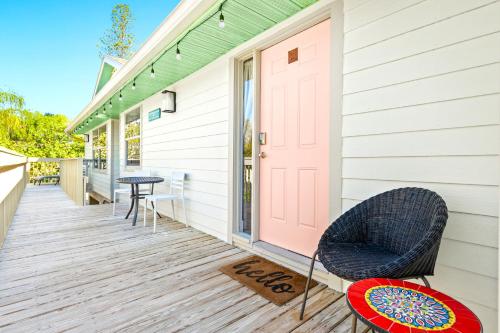 a front porch of a house with a pink door at Newly remodeled 8-steps to sand path of Beach! Unit A in Siesta Key