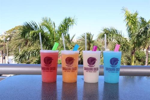 a group of four different colored drinks sitting on a table at Newly remodeled 8-steps to sand path of Beach! Unit A in Siesta Key