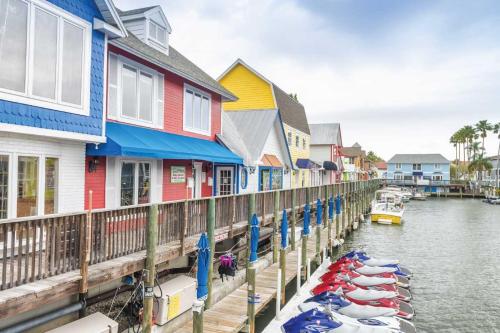 a row of colorful houses with boats in the water at Newly remodeled 8-steps to sand path of Beach! Unit D in Siesta Key