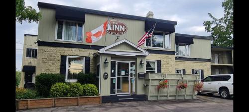 a inn with an american flag in front of it at The Inn At Lock Seven in Thorold
