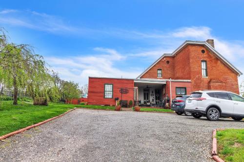a car parked in front of a brick house at DuPriest Room at Main Street Bed & Breakfast in Glasgow