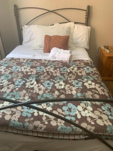 a bed with a brown and white blanket on it at Montréal Steps Downtown Private Rooms in Montreal