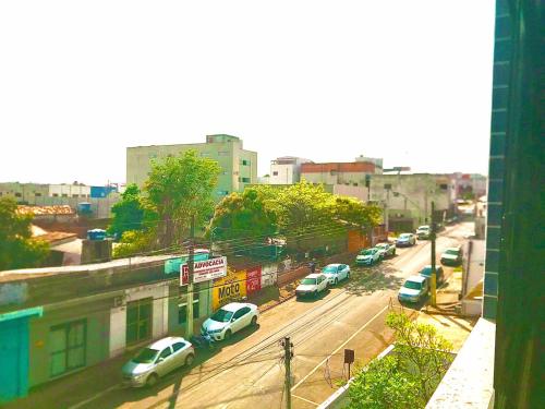 a city street with cars parked on the street at Apto 112 CENTRO in Araguaína