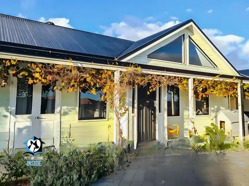 a yellow house with a black roof at A Beautiful Property, Walking Distance to the Beach in Esperance WA! in Esperance