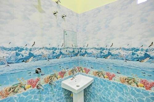 a bathroom with a sink in the water at Hotel O Dwarka in Alīgarh