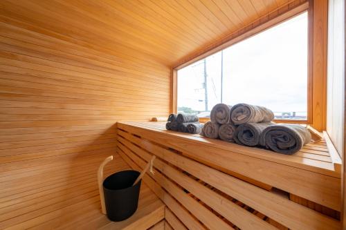 a sauna with a window and a pile of towels at akesuke in Minamiawaji